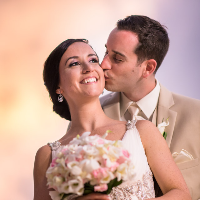 just married bride and groom with sunset backdrop